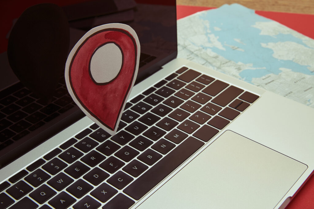 A photo of a laptop that has a pin location representing as a digital strategy